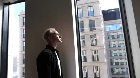 The guy in the office is standing by the window Stock Footage 138874442