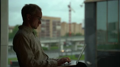 Guy at the office window Stock Footage 131511336