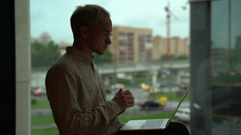 Guy at the office window Stock Footage 131511342