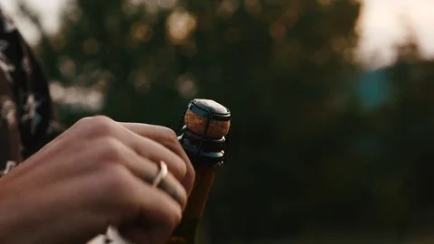 A guy opens a bottle of champagne Stock Footage 80490202