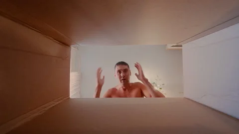 The guy opens the box and is happy to see the gift in it. Stock Footage 316911598