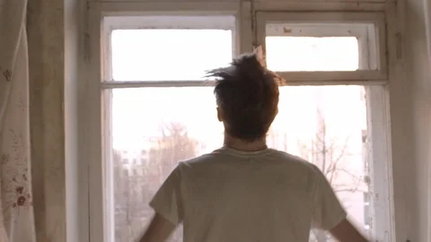 The guy opens the curtains and dresses Stock Footage 104260611
