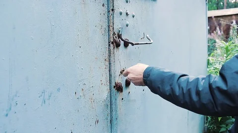 The guy opens the garage door with a key Stock Footage 113859204