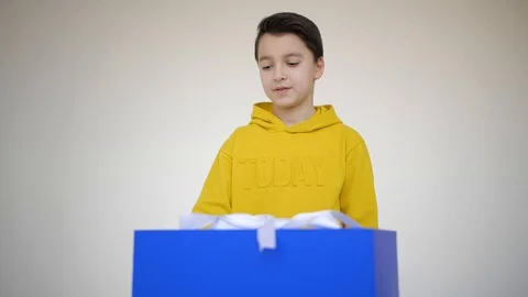 Guy opens a gift with a cat Stock Footage 128047877