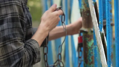 The guy opens the old gate. Abandoned plot of land. Stock Footage 292007697