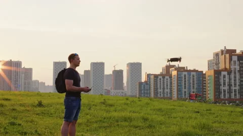 Guy operates with remote control aerial mobile drone Video stock 202210151