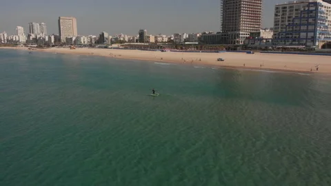 A guy with a paddle standing on a surfboard, top view Stock Footage 147476206