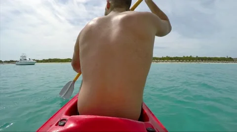 Guy Paddling a Small Canoe in Caribbean Islands Stock Footage 52653745