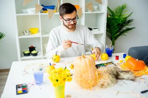 Guy painting pumpkins Stock Photos