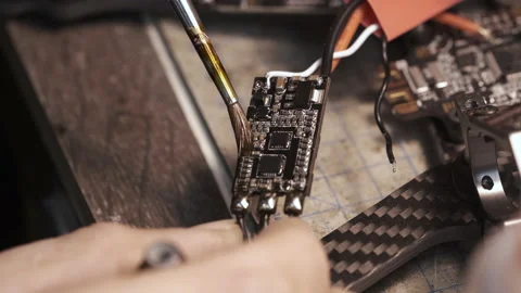 The guy paints the FPV chip of the drone with a brush Stock Footage 139548567