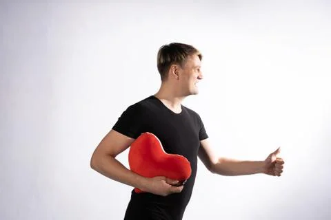 The guy is in the palms of a heart for Valentines day on white background Foto stock