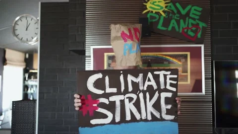 A guy with a paper bag on his head with a demonstrative "No plastic" Stock Footage 148476034