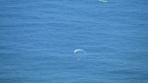 A guy on a paragliding in a really blue view, on top of the ocean Stock Footage 91753360