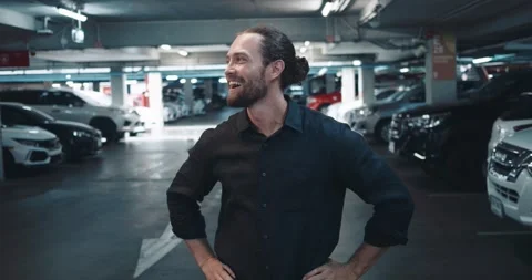 Guy in parking lot experiences happy emotions from long-awaited meeting. Man is Stock Footage 256298588