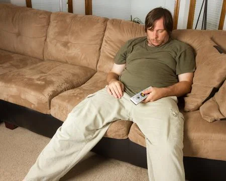 Guy passed out on the couch Stock Photos