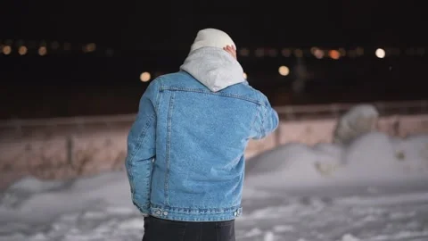 A guy with a pensive look walks along a snowy street Stockbeeldmateriaal 147070973