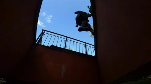 A guy performs acrobatics on the street, parkour Stock Footage 252490654
