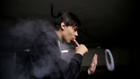 Guy performs beautiful tricks with vapor