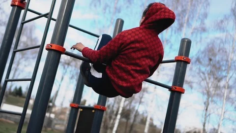 The guy performs dynamic exercises and tricks on the bar. Very dynamically Stock Footage 129045969
