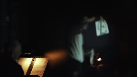 Guy performs in the theater with a music book and shows a performance Stock Footage 162816923