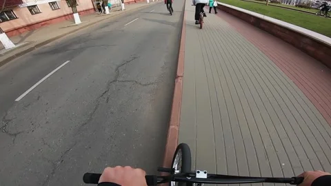 A guy performs a trick on a bicycle, jumps down the stairs Stock Footage 195558293