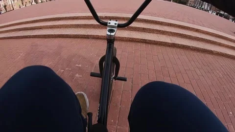 A guy performs a trick on a bicycle, jumps down the stairs Stock Footage 195558795