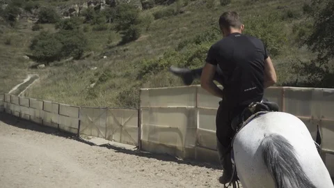 Guy performs a trick on a horse Stock Footage 96000300