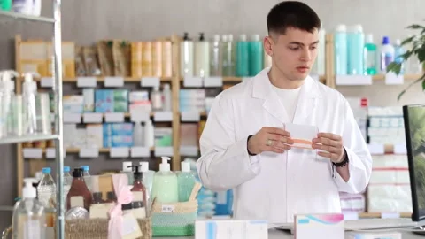 Guy pharmacist at counter with computer offer tablets, consulting girl about Stock Footage 331306424