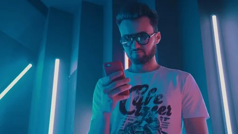 The guy with the phone in neon Stock-Footage 128919542