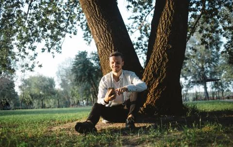 A guy with a phone in park Stock Photos