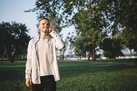 A guy with a phone in park Stock Photos