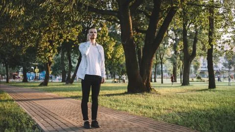 A guy with a phone in park Stock Photos