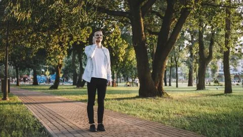 A guy with a phone in park Stock Photos