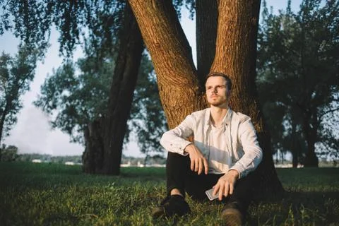 A guy with a phone in park Stock Photos