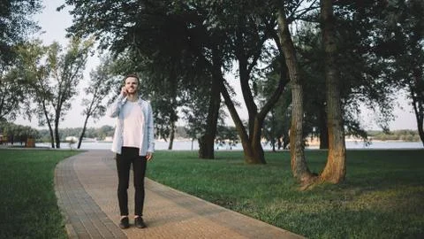 A guy with a phone in park Stock Photos
