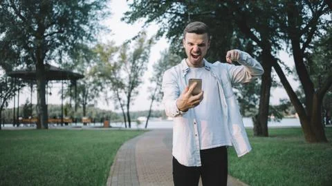 A guy with a phone in park Stock Photos