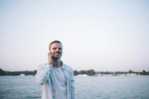 A guy with a phone in park Stock Photos