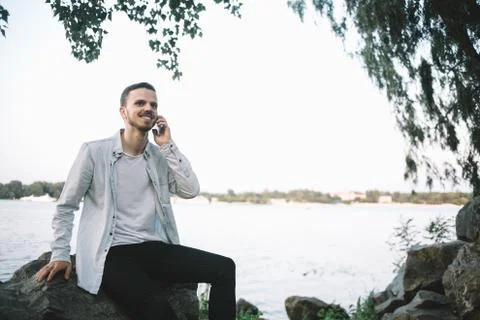A guy with a phone in park Stock Photos
