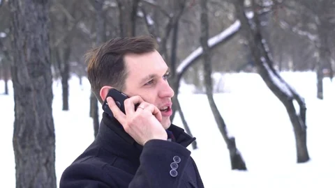 The guy on the phone in the winter Stock Footage 83157374