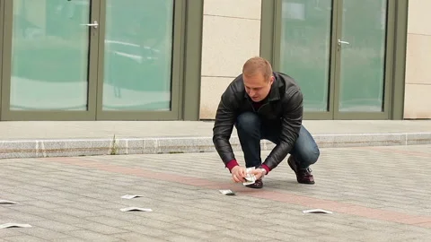 Guy picking up a lot of dollar bills from the ground. Luck and sudden income Stock Footage 97470632