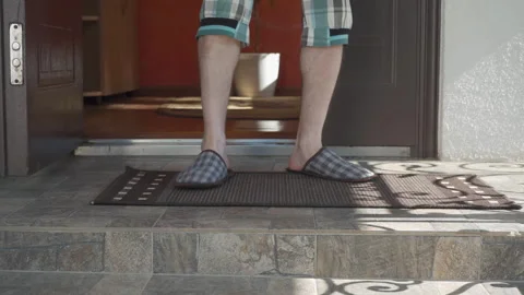 Guy picks up box parcel at door Stock Footage 318167376