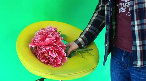 The guy picks flowers on a green background Video stock 60745216
