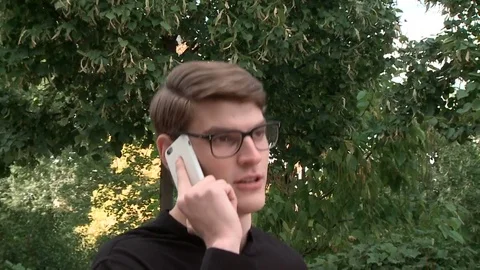 The guy picks up the phone and talks on the phone Stock Footage 79527824