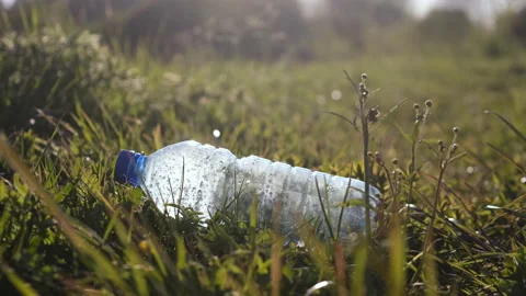 The guy picks up a plastic bottle close up. Trash-free planet concept. Stock Footage 130925730