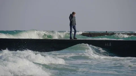The guy on the pier is talking on the phone during a storm. Stock Footage 82213631