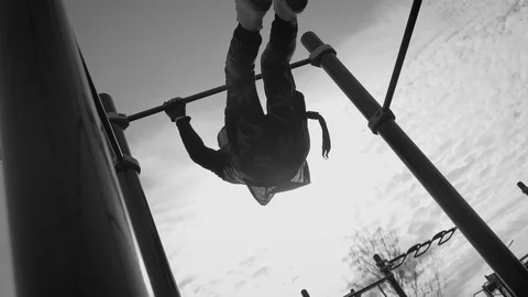 Guy on the playground makes a coup on the street in sunny weather, for his body Stock Footage 126858640