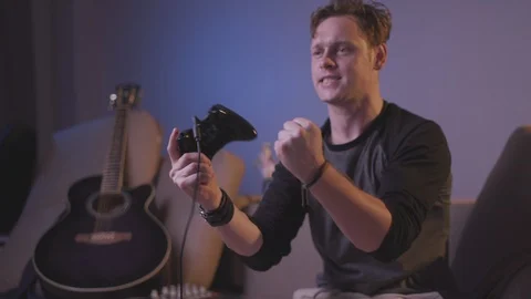 The guy is playing a computer game Stock Footage 118857821