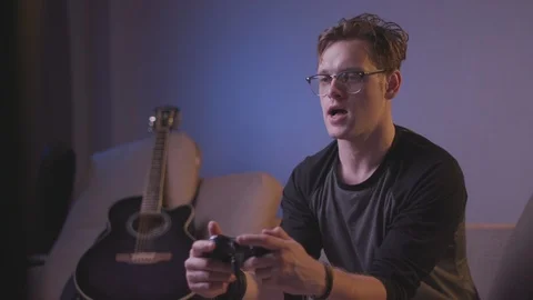 The guy is playing a computer game Stock Footage 118857829