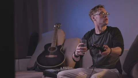 The guy is playing a computer game Stock Footage 118857835