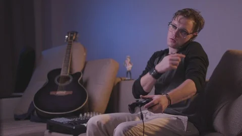 The guy is playing a computer game Stock Footage 118857845